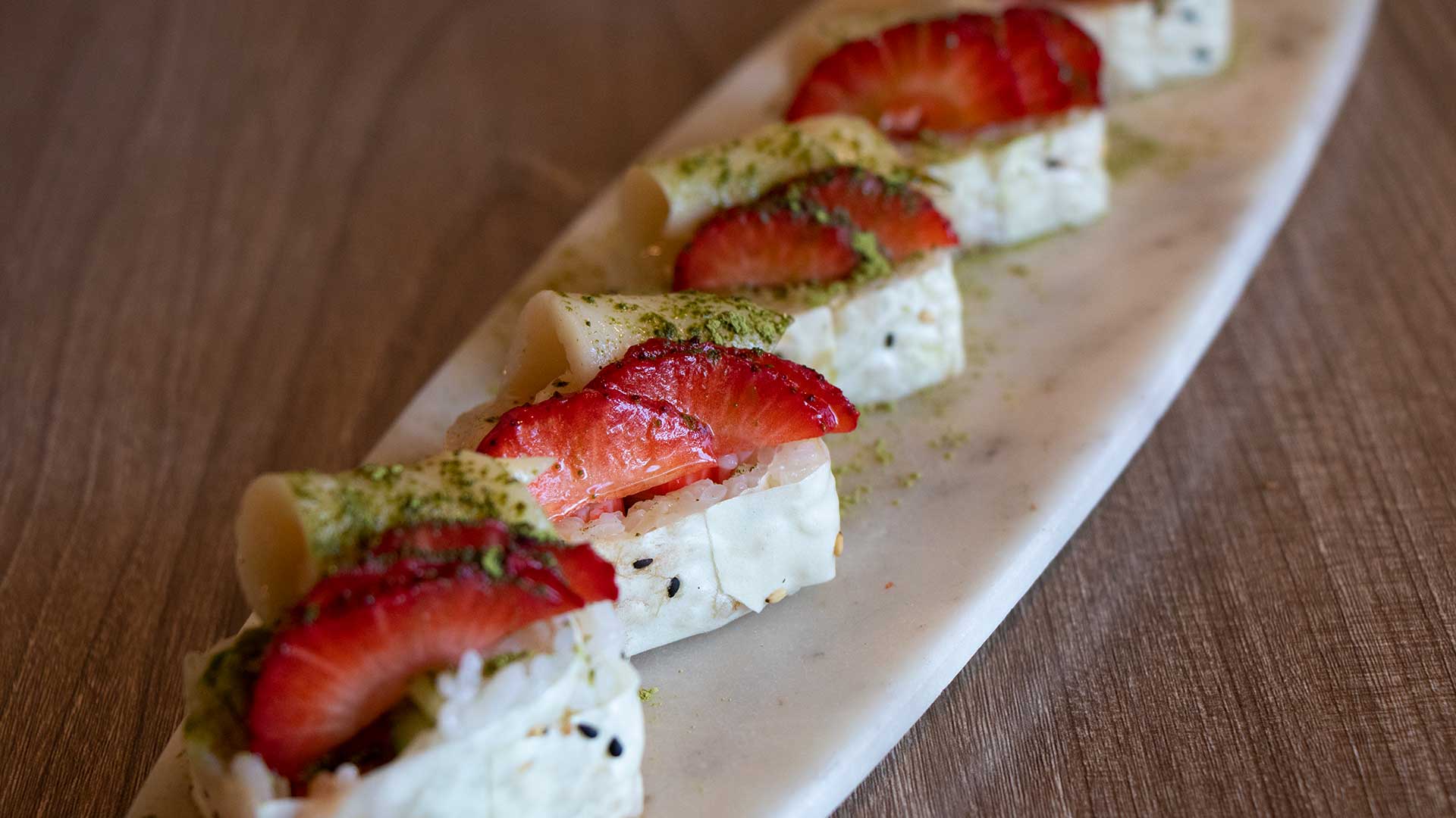 Strawberry Field sushi roll topped with matcha powder